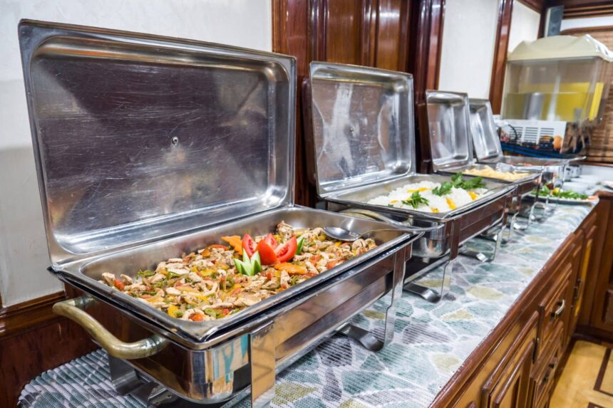 Chafing dishes of chicken and rice laid out on the Emperor Superior's buffet