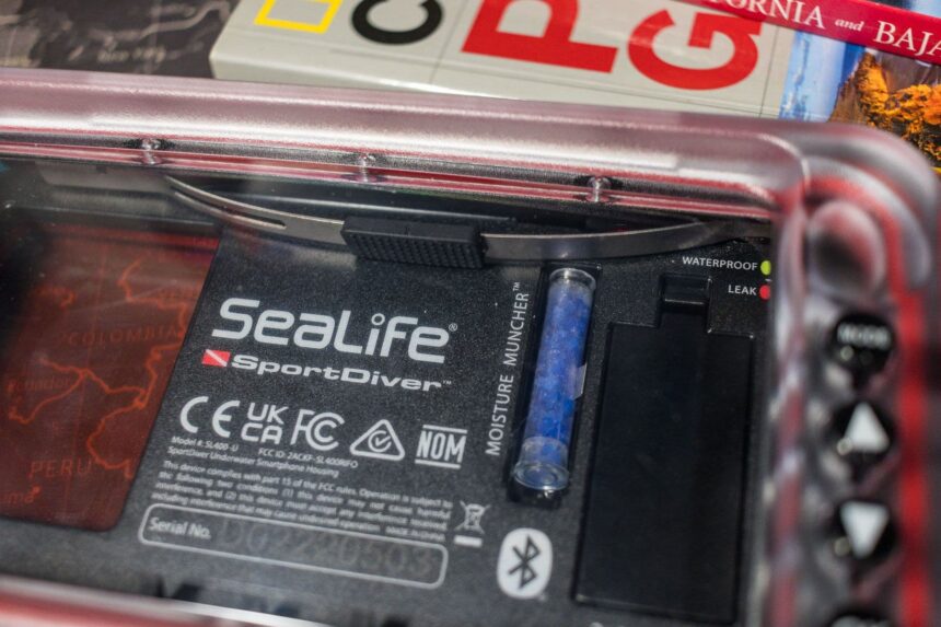 Inside of the SeaLife SportDiver housing showing the Moisture Muncher desiccant tube and leak warning lights