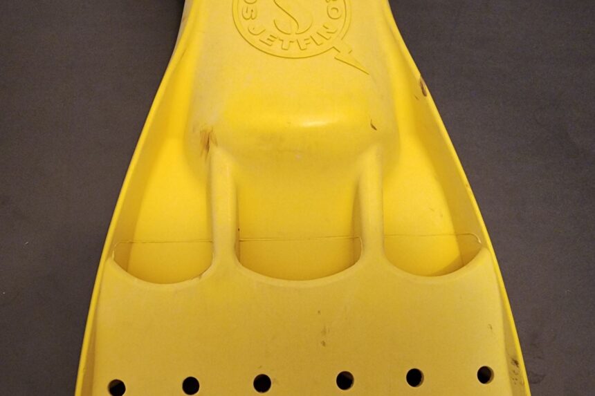 Top of a yellow ScubaPro Jet Fin blade showing the vented channels and molded Jet Fin logo