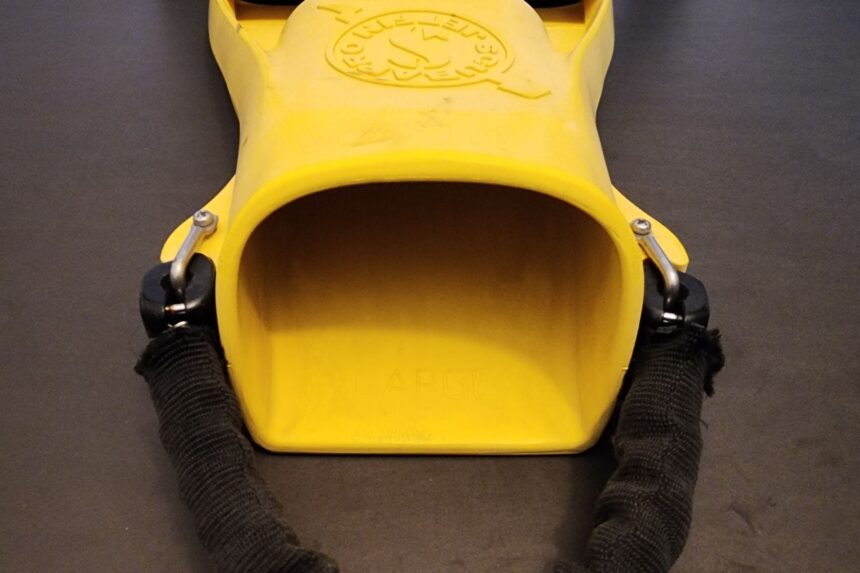 Open foot pocket of a yellow ScubaPro Jet Fin with stainless spring straps on both sides