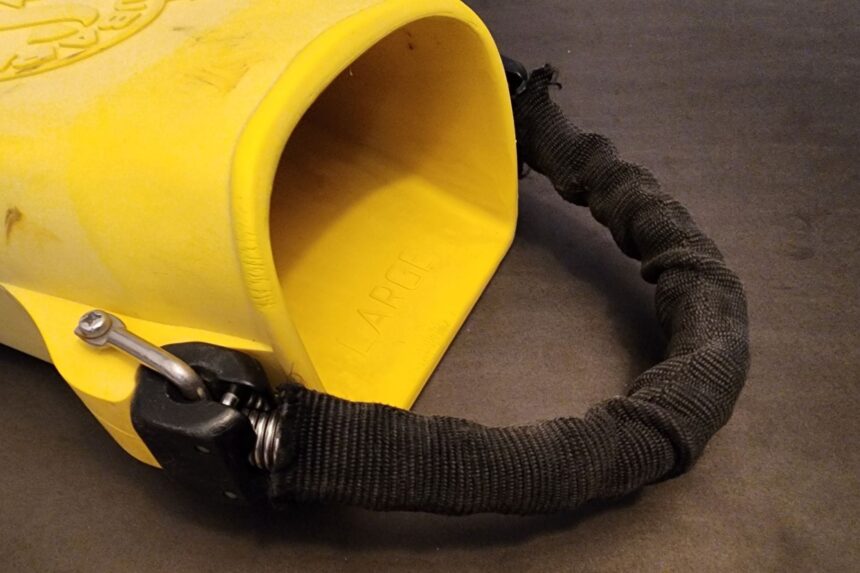 Angled close-up of the ScubaPro Jet Fin foot pocket and its nylon-sleeved stainless spring strap