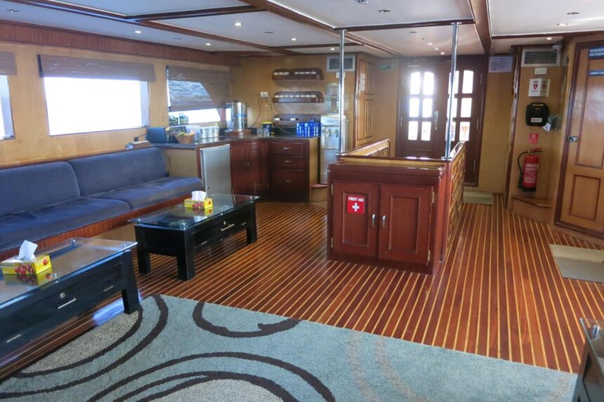 Salon seating area aboard the Blue Voyager with a galley and first aid station