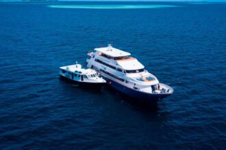 Blue Voyager liveaboard yacht underway with a bow wave