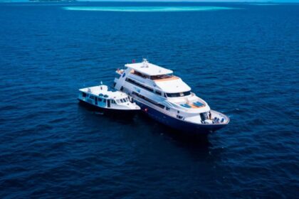 Blue Voyager liveaboard yacht underway with a bow wave