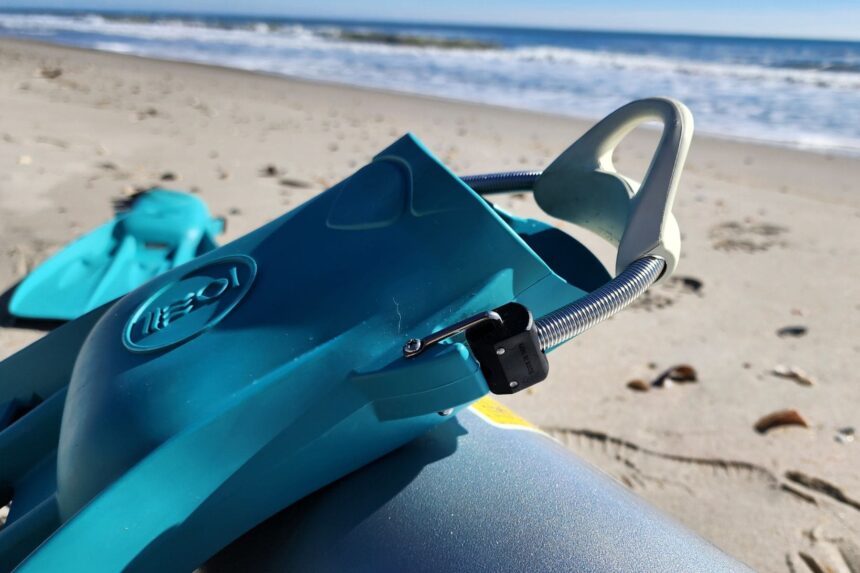 Close-up of the Tech fin stainless spring strap and pale rubber heel pad on the beach
