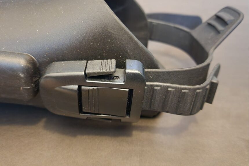 Close-up of the closed quick-release buckle holding the heel strap on an Atomic Aquatics SplitFin