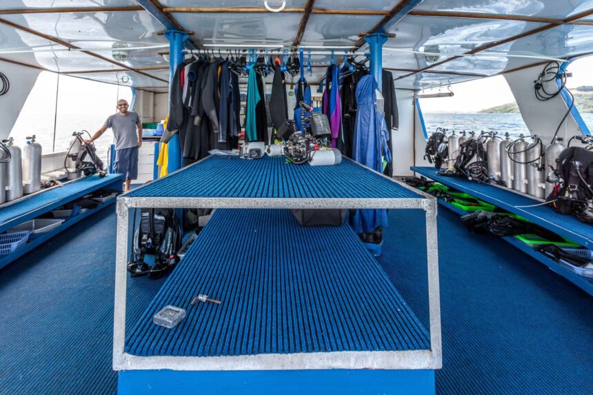 Dive deck of the Emperor Bilikiki lined with wetsuits and scuba tanks