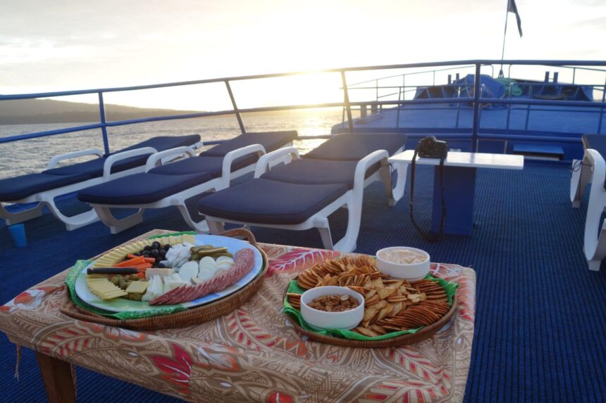 Sunset spread of cheese, crackers and dips laid out on the Bilikiki's deck