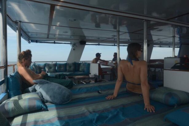 Guests relaxing on cushioned deck seating aboard The Smiling Seahorse liveaboard