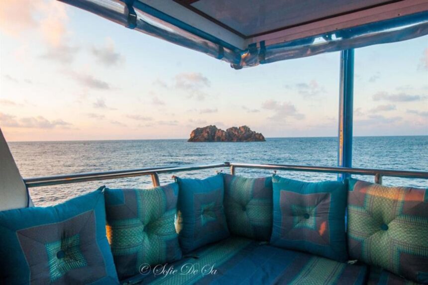 View of a small rocky island from a cushioned lounge area on The Smiling Seahorse