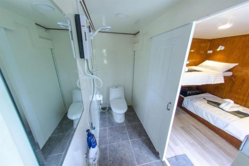 Ensuite bathroom with twin toilets and shower connecting to a cabin on The Smiling Seahorse