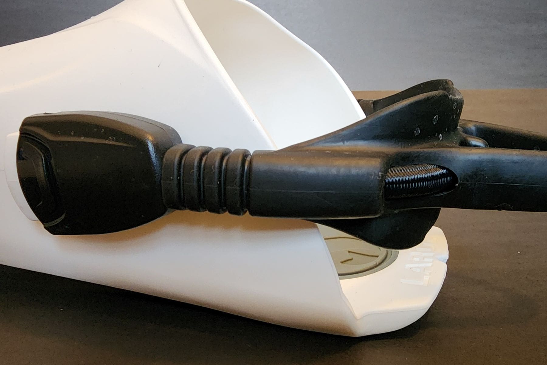 White open-heel fin fitted with a black bungee heel strap and rubber heel pad