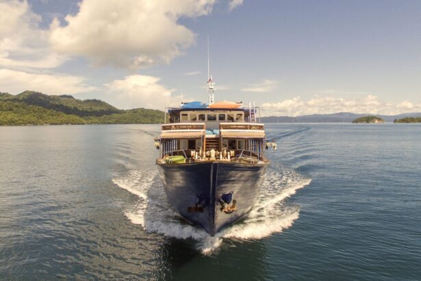 Ambai liveaboard underway with guests relaxing on the bow deck