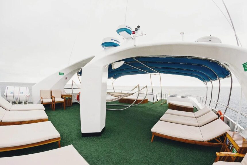 green astroturf sundeck with lounge chairs and hammocks on the Galapagos Sky