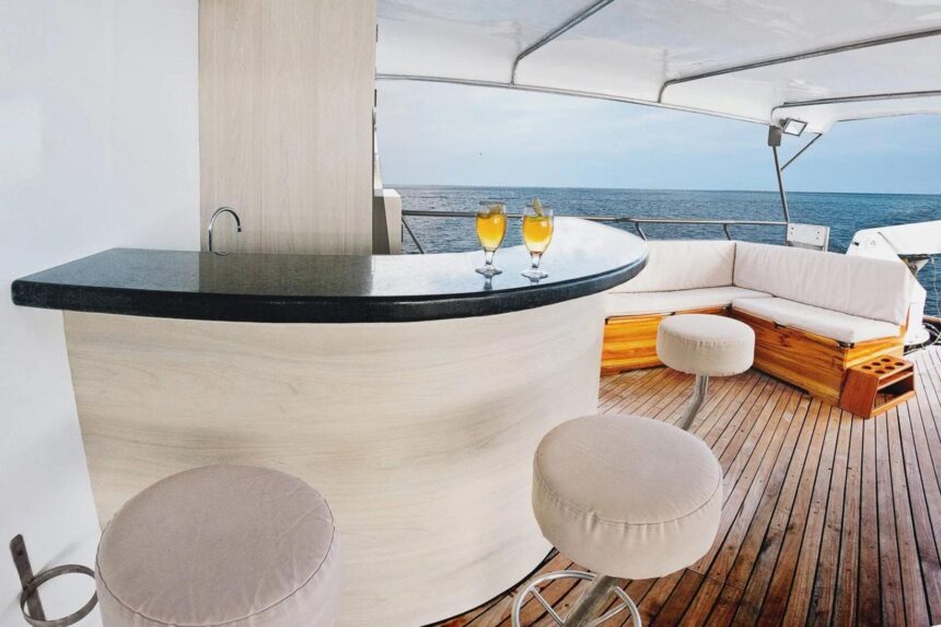 outdoor deck bar with stools and cocktails aboard the Galapagos Sky