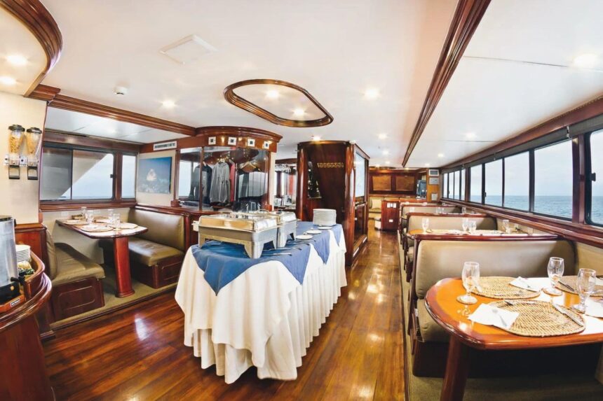 formal dining table set with white linens aboard the Galapagos Sky