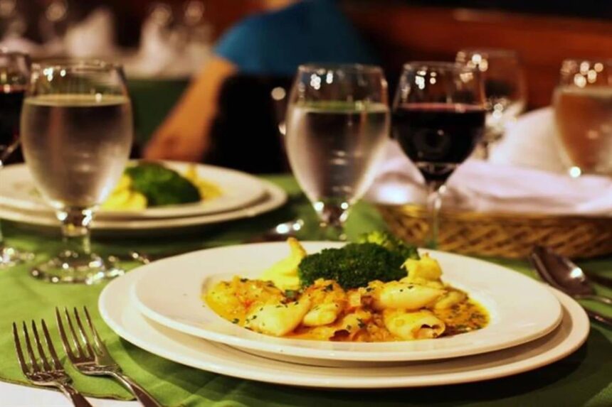 plated seafood dinner with wine and water glasses on the Galapagos Sky