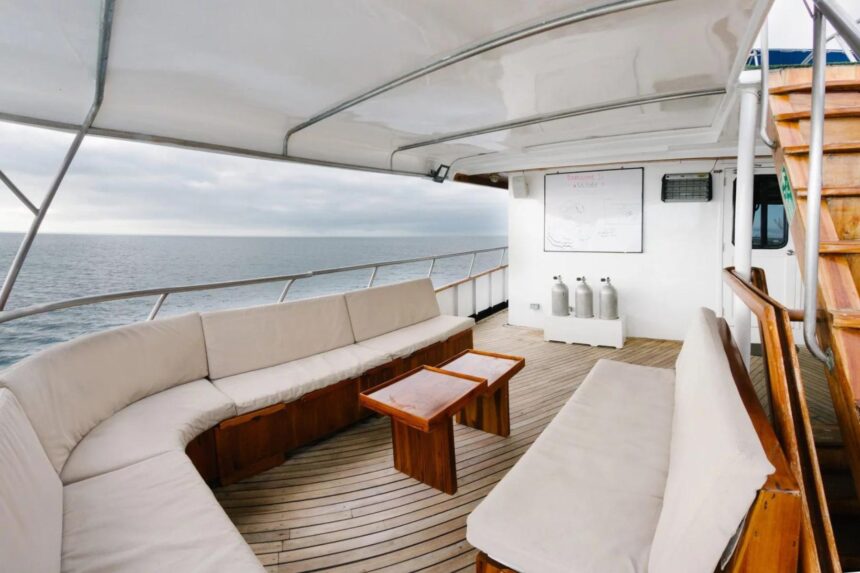 covered lounge seating area with a dive briefing board on the Galapagos Sky