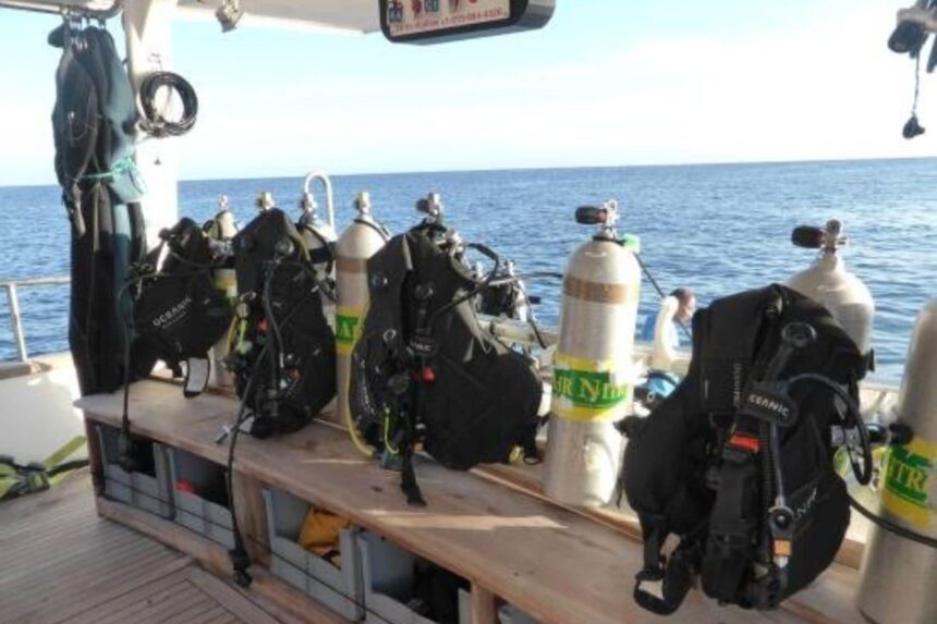 scuba gear including BCDs and nitrox tanks set up on the Nortada's dive deck