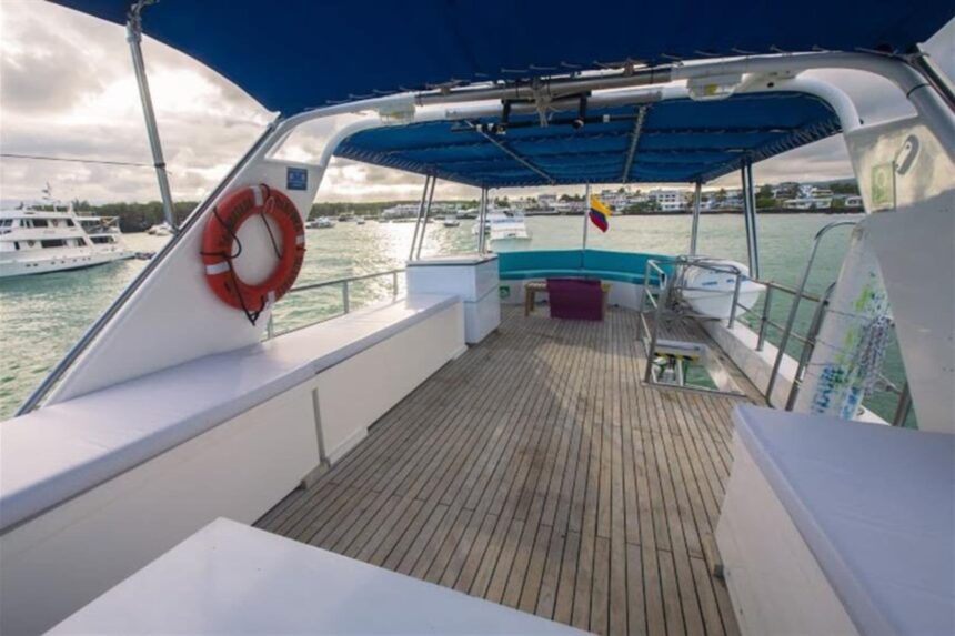 the Nortada's stern deck with a life ring and moored boats in the harbor