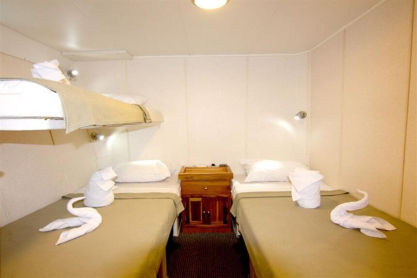 twin cabin aboard the Nortada with bunk berths and towel swans on the beds