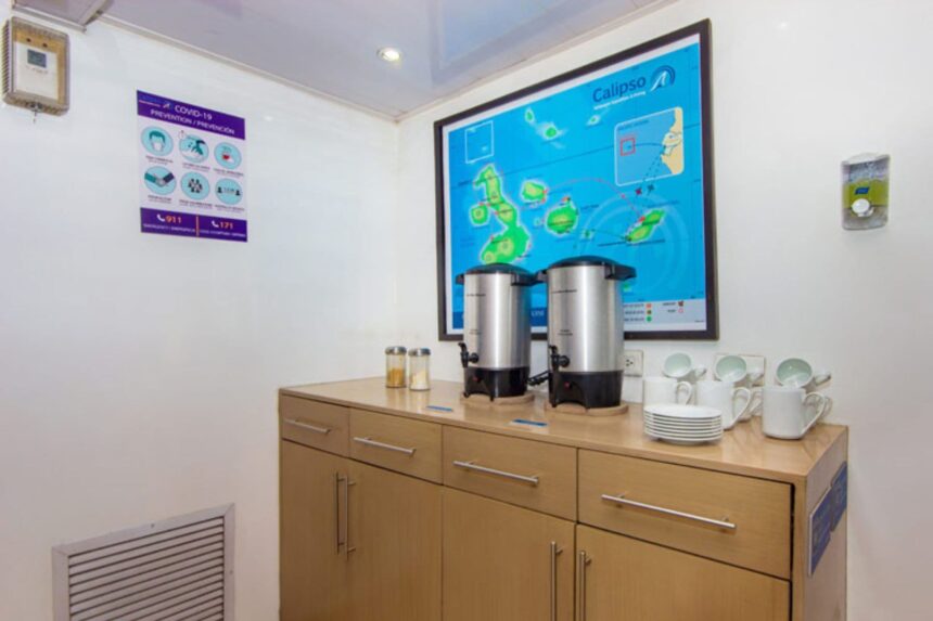 coffee urns and stacked cups on a cabinet aboard the Calipso