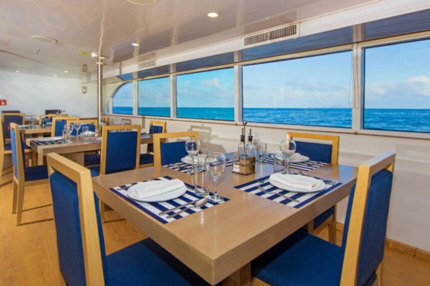 a dining table is set with plates, glasses and napkins ready for dinner
