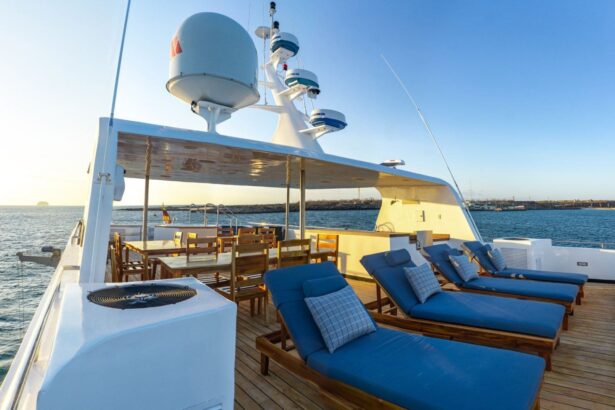 blue lounge chairs on the Calipso's upper deck at sunset