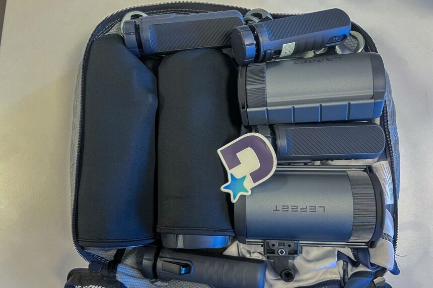 Two LEFEET P1 scooters and their hand remotes packed inside a medium packing cube