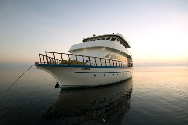 liveaboard yacht anchored on calm water at sunrise