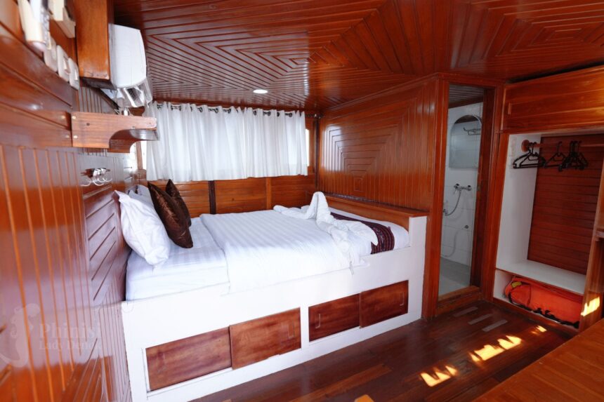 wood trimmed double cabin bed aboard Lady Denok