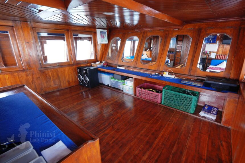wood paneled storage area with crates aboard Lady Denok