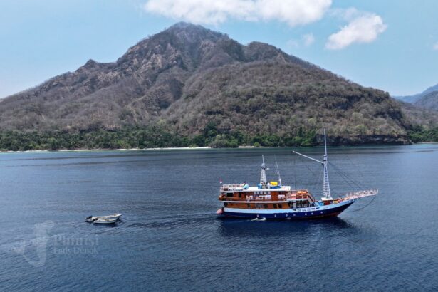 Lady Denok anchored near a forested mountain in Indonesia