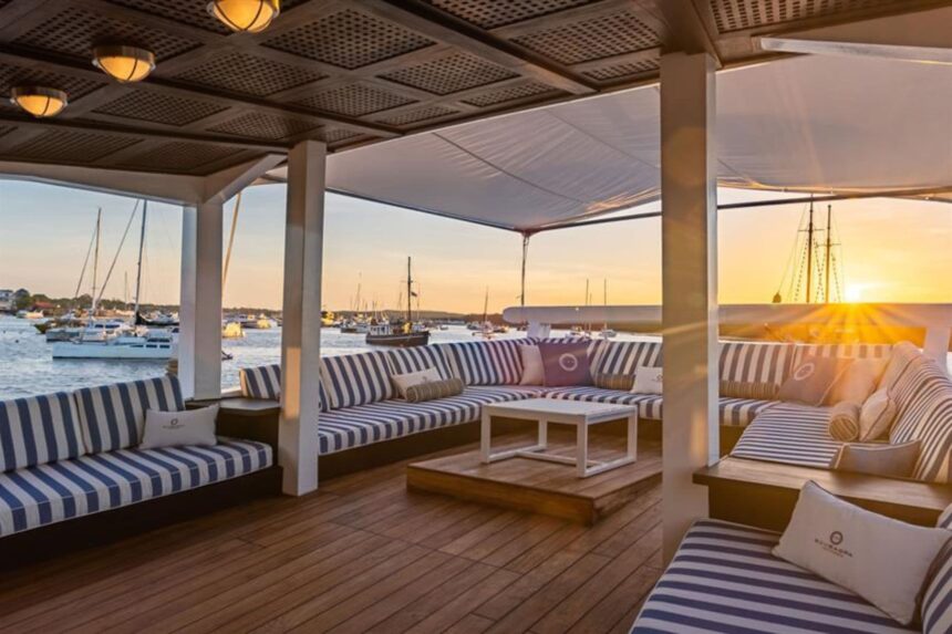 Sunset lounge deck with striped cushioned seating aboard Scubaspa Zen