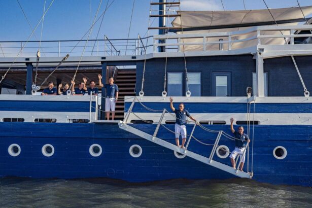 Scubaspa Zen crew waving from the boat's gangway and deck