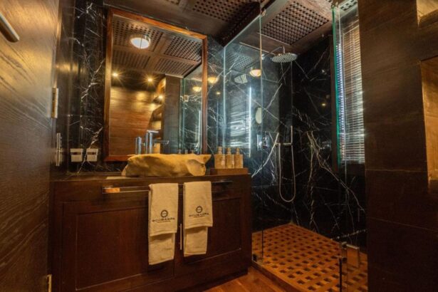 Marble bathroom with glass shower and Scubaspa branded towels aboard Scubaspa Zen