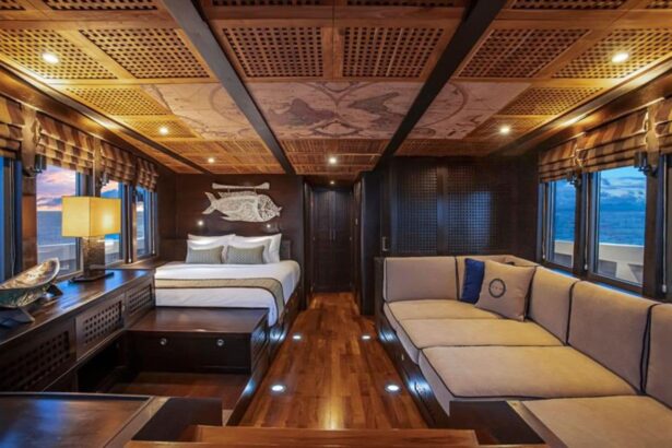Cabin aboard Scubaspa Zen with a map-motif ceiling, bed and lounge seating