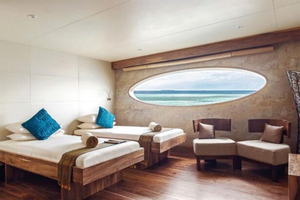 Twin cabin aboard Scubaspa Yin with an oval window overlooking the sea
