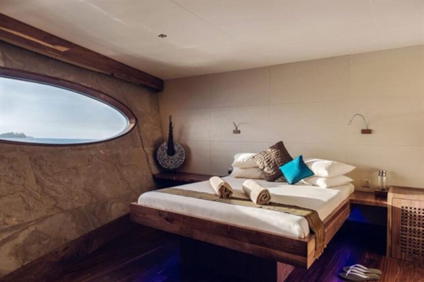 Cabin aboard Scubaspa Yang with an oval window overlooking the ocean