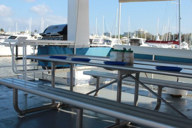 Empty picnic tables set on the MV SeaEsta's deck beside the marina