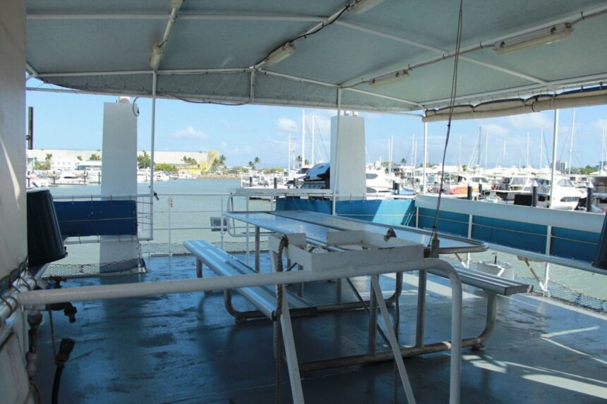 Covered outdoor dining table on the deck of MV SeaEsta at the marina
