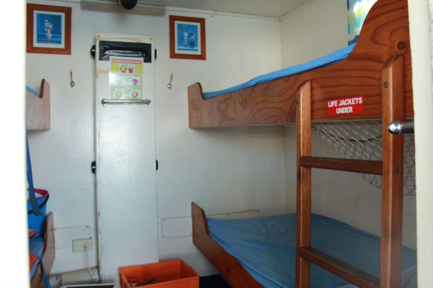 Cabin with bunk beds and framed pictures aboard MV SeaEsta liveaboard