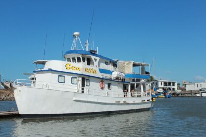 MV SeaEsta liveaboard docked at a marina under clear blue sky