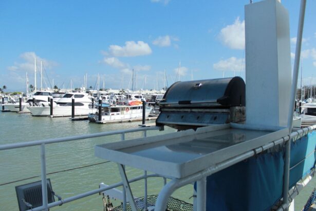Barbecue grill mounted on the rail of MV SeaEsta with the marina behind