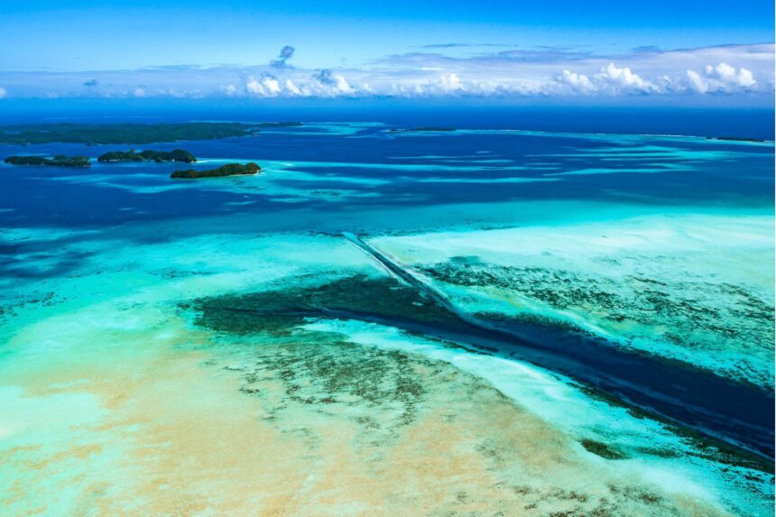Aerial view of the German Channel cutting a dark line through Palau's shallow turquoise reef flats