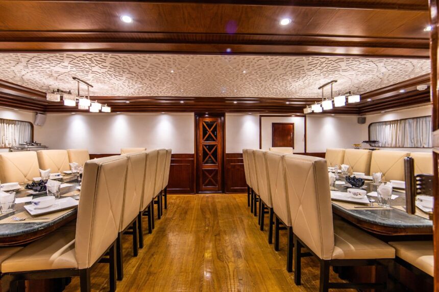 Long dining table set for guests aboard the Aphrodite liveaboard