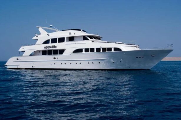Side view of the Aphrodite liveaboard cruising on calm blue water