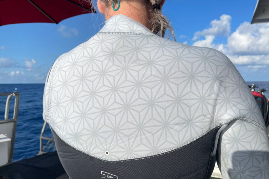 Close-up of the patterned light neoprene across the shoulders of the Aqualung XSCAPE on a dive boat