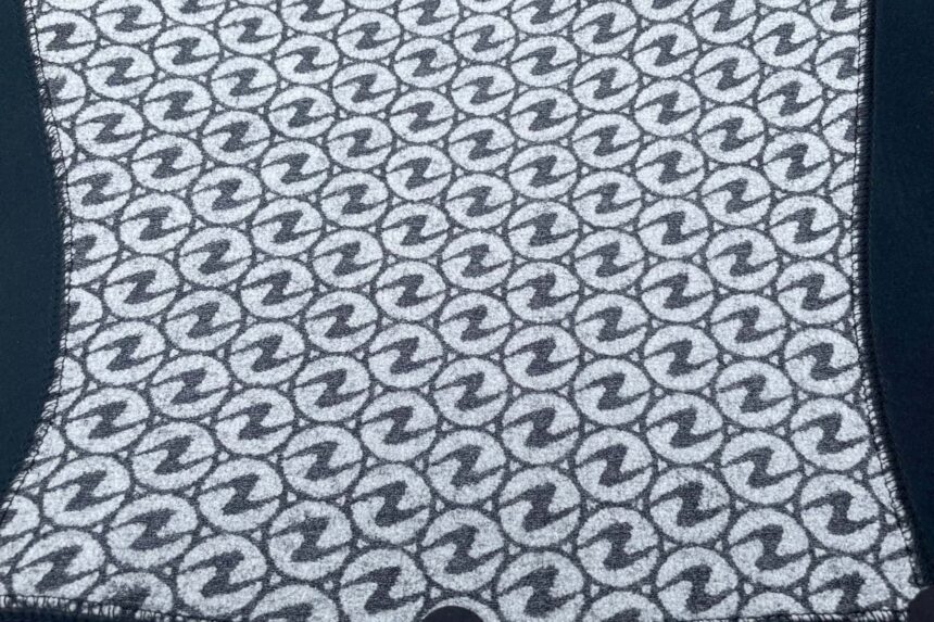 Close-up of the Aqualung XSCAPE inner liner printed with repeating Aqualung logos