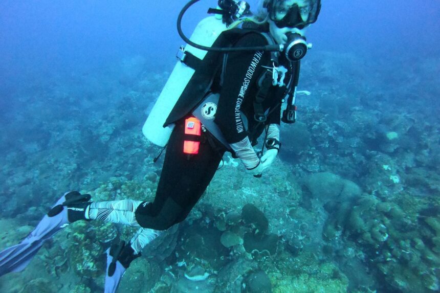 Sherwood Marine Conservation Wetsuit Dive DIVEIN tester diving the Sherwood Scuba Marine Conservation wetsuit over a shallow reef